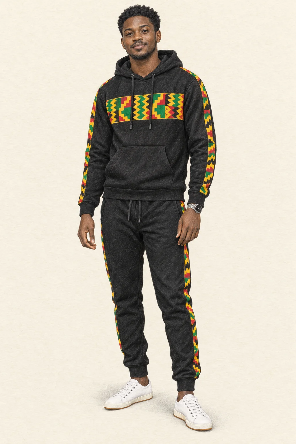 Fictional young man in a black hoodie and joggers with bright printed bands, white canvas sneakers and a silver watch.